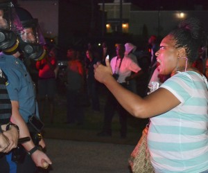            Angry protester confronts police at vigil for Mike Brown, murdered by Ferguson police.